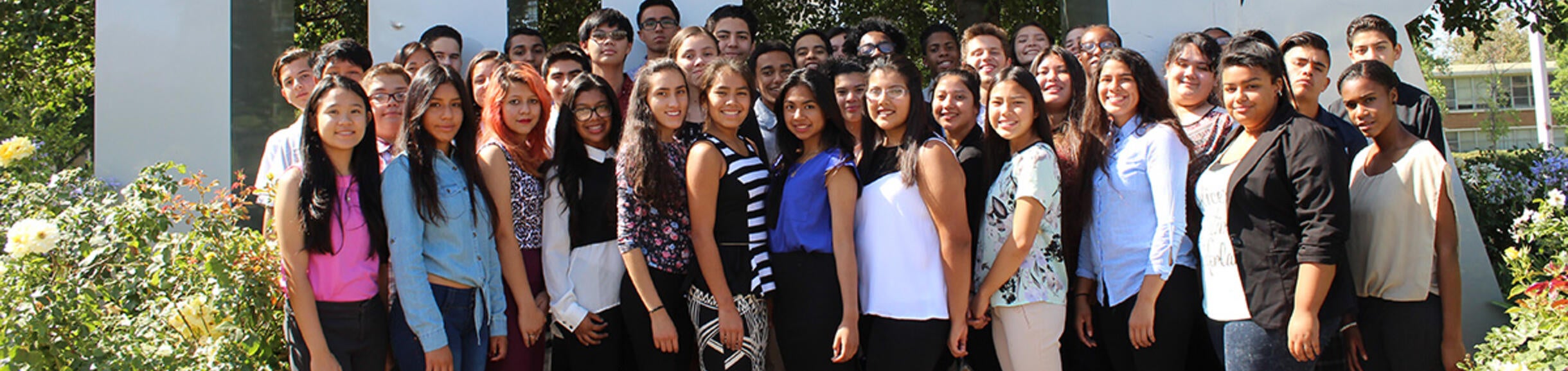 students in front of the UCR signage