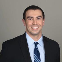 Dr. Ruiz in a suit and tie smiling for his headshot 